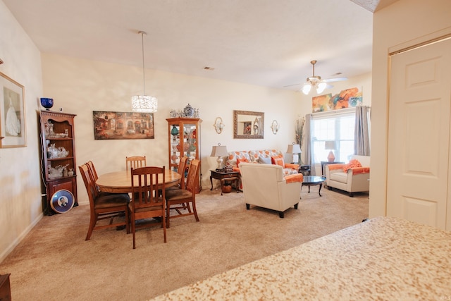 dining room with light carpet and ceiling fan