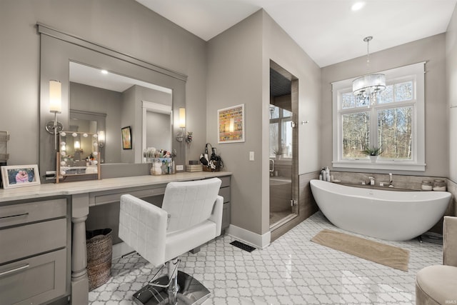 bathroom featuring vanity, independent shower and bath, and a notable chandelier