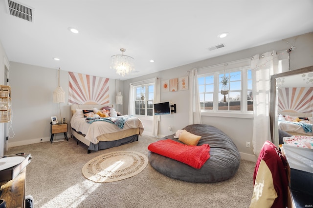 bedroom with an inviting chandelier and carpet