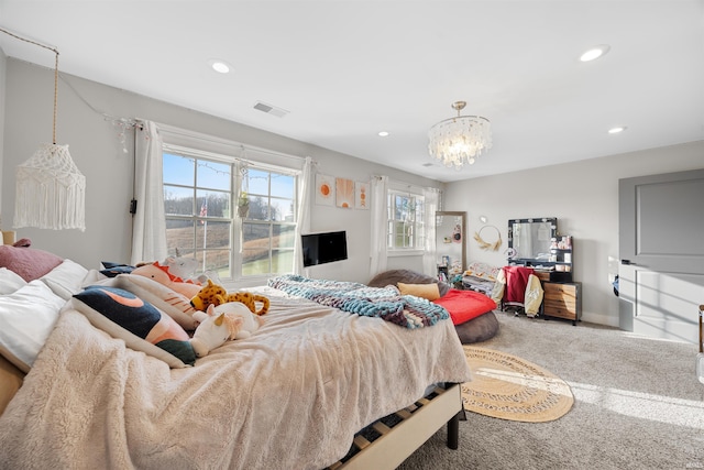 carpeted bedroom featuring a chandelier