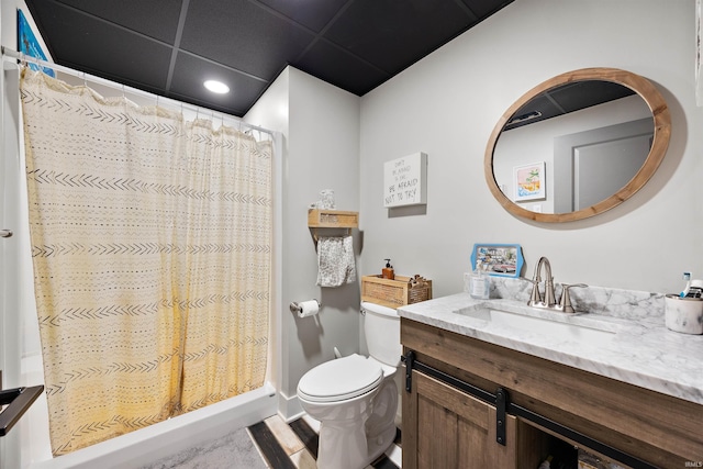 bathroom with toilet, vanity, a shower with shower curtain, and a paneled ceiling