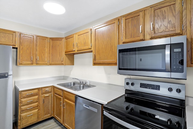 kitchen featuring sink, appliances with stainless steel finishes, and light wood-type flooring