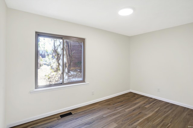 empty room with dark wood-type flooring