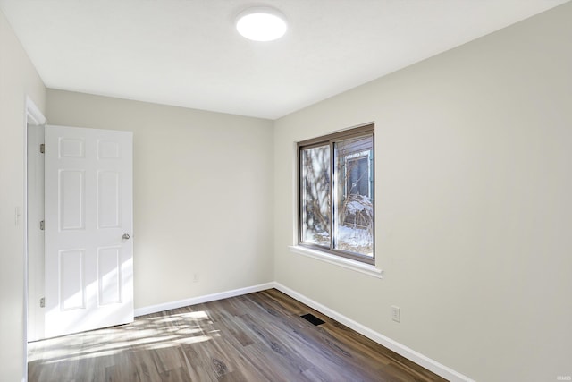 unfurnished room featuring dark hardwood / wood-style floors