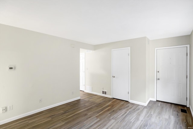 spare room featuring wood-type flooring