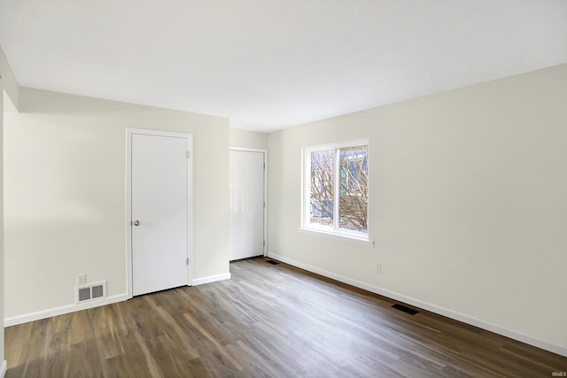 spare room with dark wood-type flooring