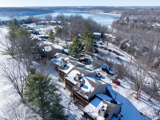 snowy aerial view with a water view