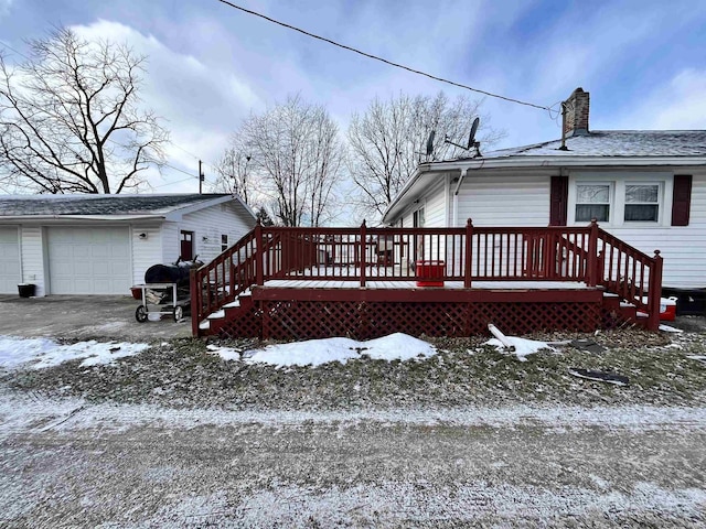 snow covered deck featuring a garage