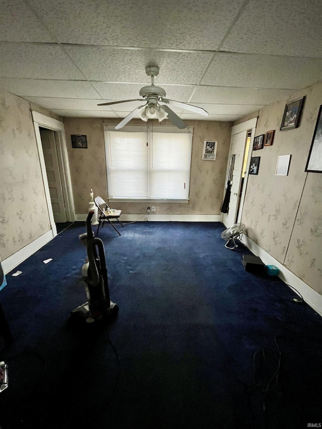 spare room featuring ceiling fan and a drop ceiling