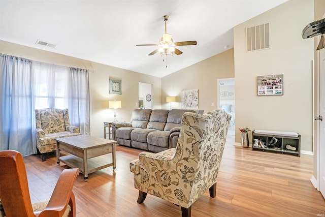 living room featuring ceiling fan, light hardwood / wood-style flooring, and lofted ceiling