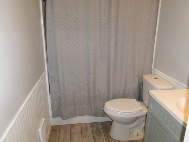 bathroom featuring hardwood / wood-style flooring, toilet, and vanity