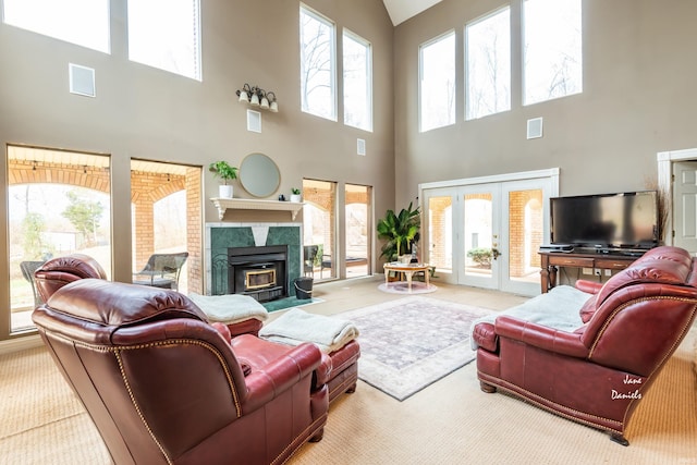 living room with a wealth of natural light, carpet, and a towering ceiling