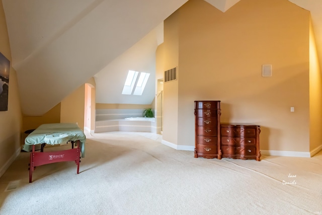 additional living space with vaulted ceiling with skylight and carpet