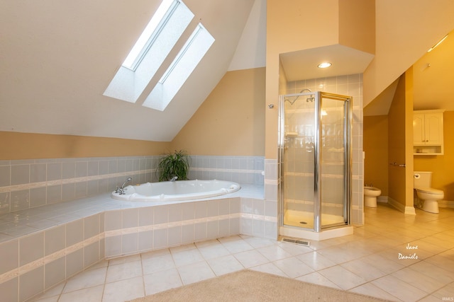 bathroom with toilet, tile patterned flooring, vaulted ceiling with skylight, plus walk in shower, and a bidet