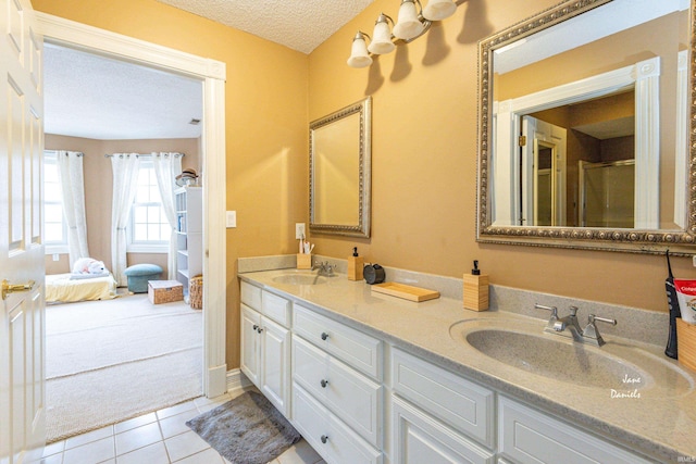 bathroom with vanity, tile patterned flooring, and a textured ceiling