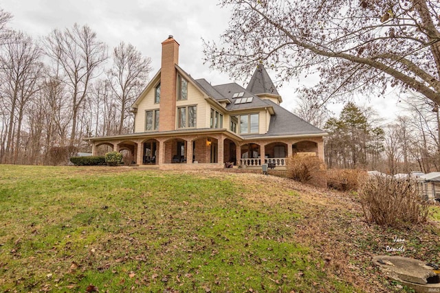 rear view of property with a yard