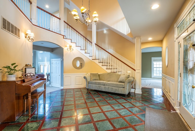 living room featuring an inviting chandelier and a high ceiling