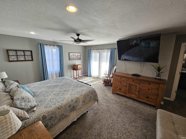 carpeted bedroom featuring ceiling fan and a textured ceiling