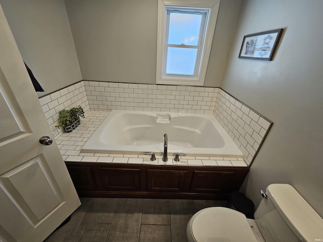 bathroom with toilet and a bathing tub