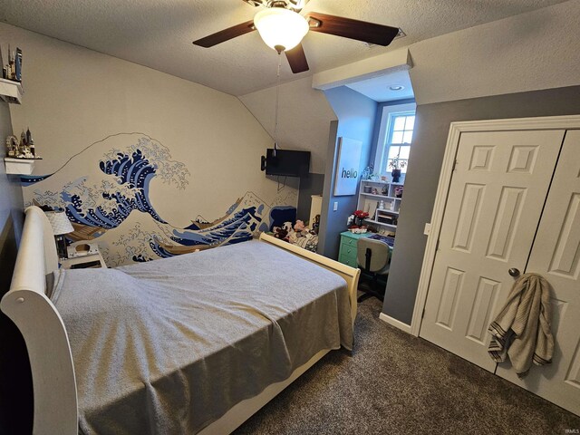 bedroom featuring a textured ceiling, ceiling fan, and dark colored carpet