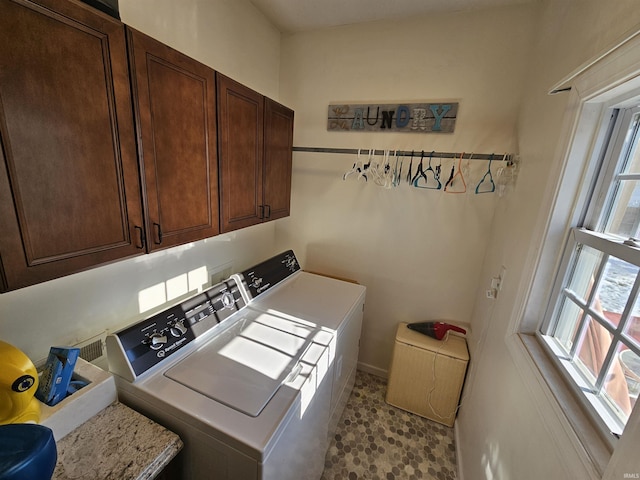 laundry area with washing machine and dryer and cabinets