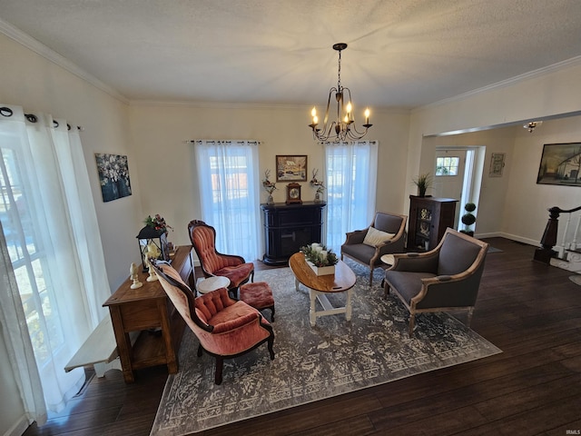 living room featuring dark wood-type flooring, plenty of natural light, crown molding, and a textured ceiling