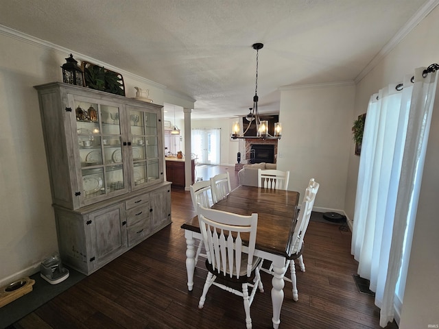 dining area featuring dark hardwood / wood-style floors, crown molding, and a textured ceiling