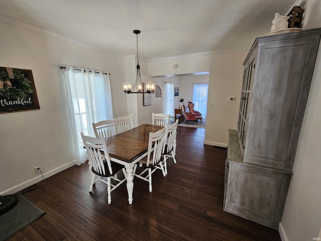 dining room with dark hardwood / wood-style floors, ornamental molding, and a notable chandelier