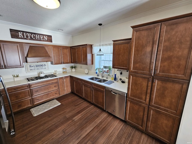 kitchen featuring premium range hood, pendant lighting, sink, appliances with stainless steel finishes, and a textured ceiling