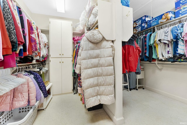 spacious closet featuring light carpet