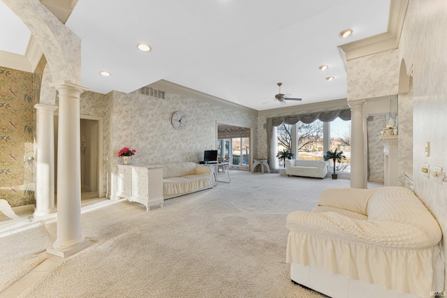 living room with ceiling fan, carpet flooring, ornamental molding, and ornate columns