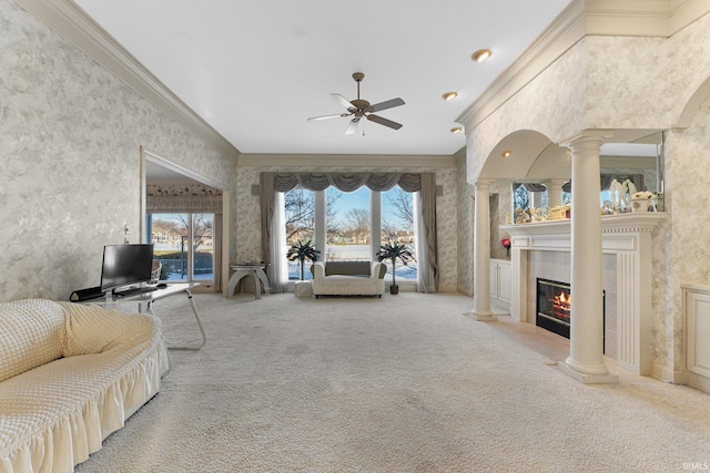 living room with ornamental molding, carpet flooring, a tile fireplace, and decorative columns