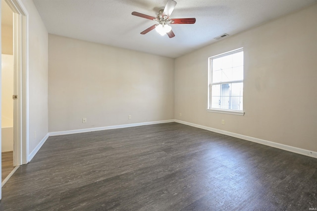 empty room featuring ceiling fan and dark hardwood / wood-style floors