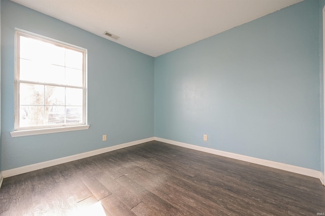 empty room featuring dark wood-type flooring