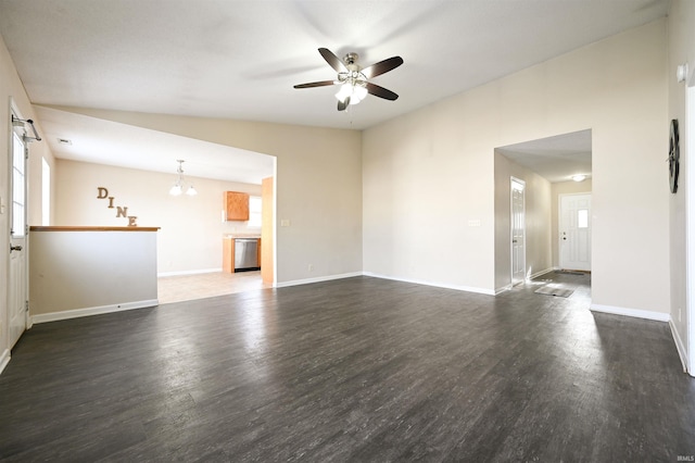 spare room featuring lofted ceiling, dark hardwood / wood-style flooring, and ceiling fan with notable chandelier