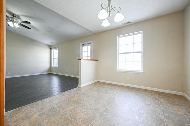 unfurnished room featuring ceiling fan with notable chandelier and a textured ceiling