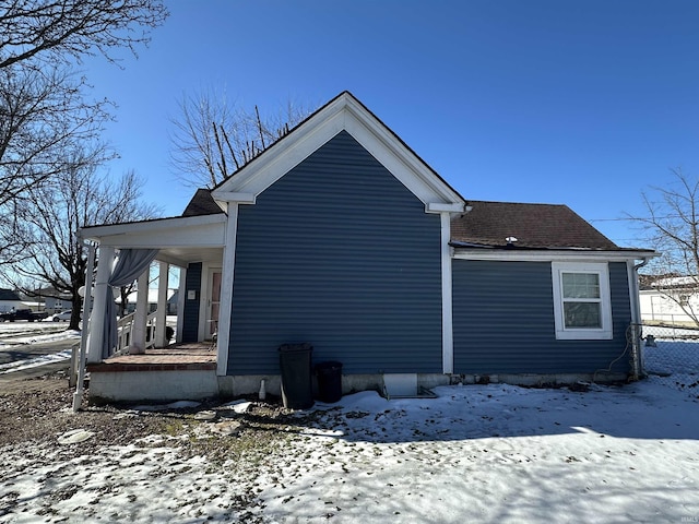 snow covered property featuring a porch