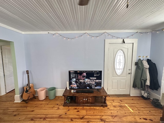 foyer with light hardwood / wood-style flooring and ornamental molding