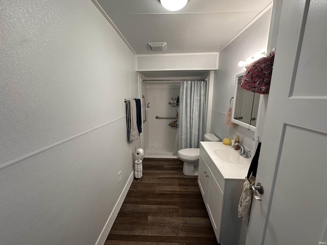 bathroom with toilet, crown molding, wood-type flooring, and vanity