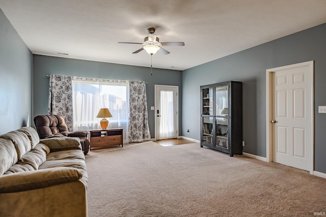 carpeted living room featuring ceiling fan