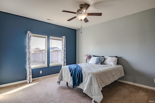 bedroom featuring ceiling fan and carpet