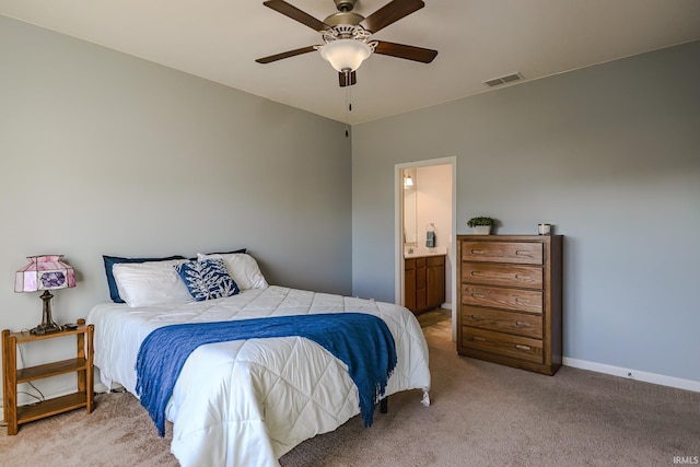 carpeted bedroom with ceiling fan and ensuite bathroom