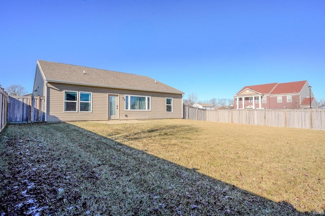 back of house with a lawn