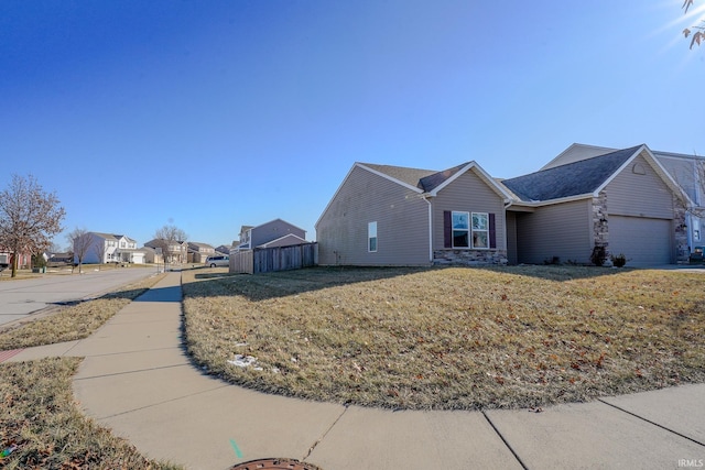 view of front of property with a garage and a front lawn