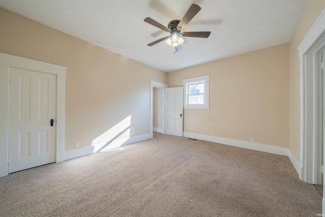 unfurnished bedroom featuring ceiling fan and carpet floors