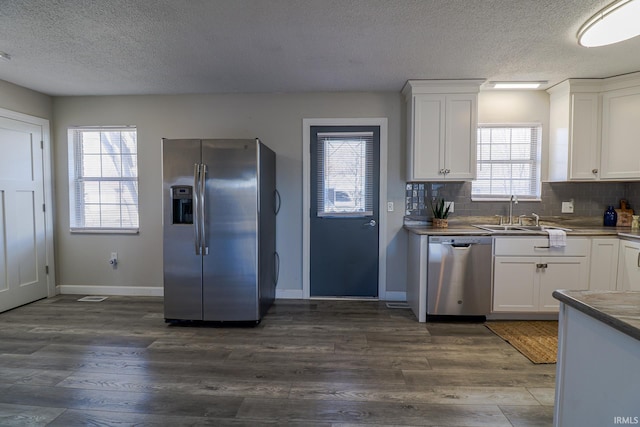 kitchen featuring sink, a wealth of natural light, white cabinets, and stainless steel appliances