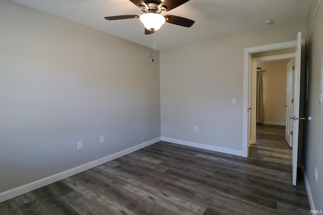 unfurnished room with ceiling fan, dark hardwood / wood-style floors, and a textured ceiling