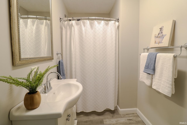 bathroom with vanity and hardwood / wood-style floors