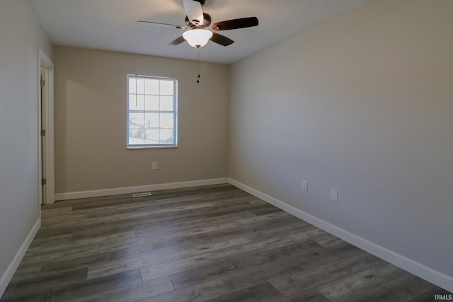 spare room with ceiling fan, dark wood-type flooring, and a textured ceiling