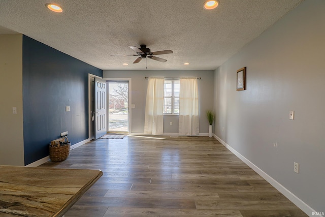 unfurnished room with ceiling fan, a textured ceiling, and hardwood / wood-style floors